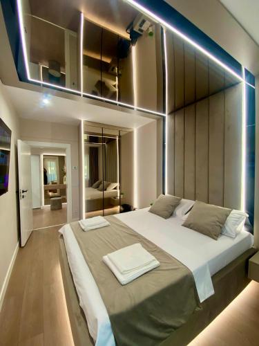 a bedroom with a large bed with lights on it at Bacovia Grand Apartment- Free Parking in Bacău