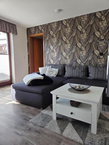 a living room with a couch and a table at Ferienwohnung Wegner in Trassenheide