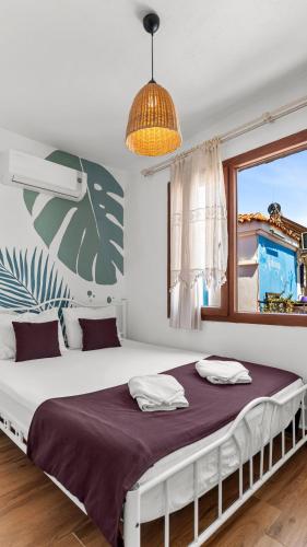 a bedroom with a large bed with a window at Casa Fiore in Seferihisar