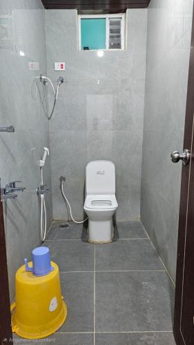 a bathroom with a toilet and a shower at Arul Rayara Residency in Mādhavaram