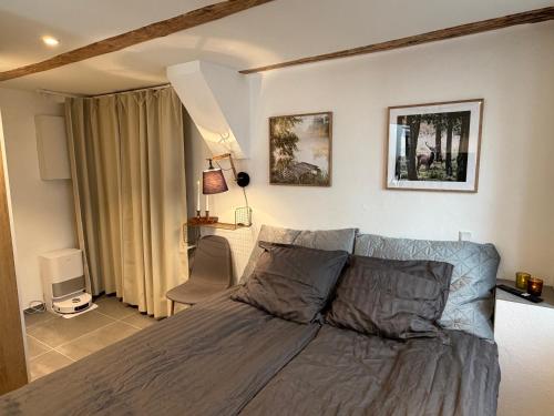 a bedroom with a bed and a chair in it at CPH Guest Homes in Copenhagen