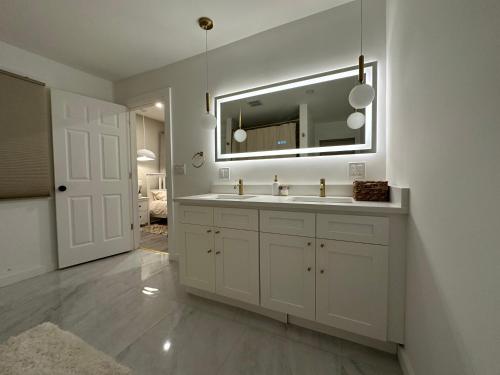 a white bathroom with a sink and a mirror at Clinton Rooms - By Outlets and Beach in Clinton