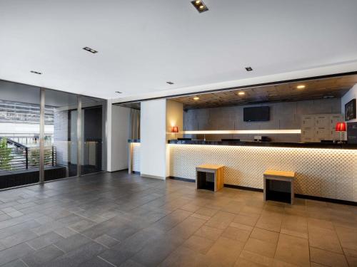 a lobby with a bar in a building at ibis Styles Kyoto Station in Kyoto
