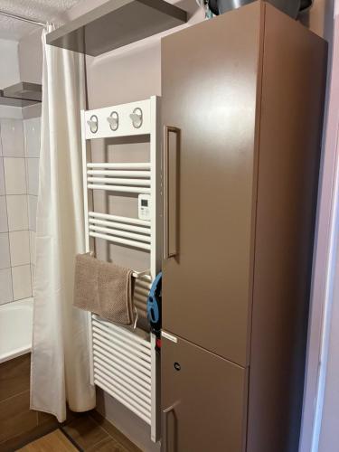 a refrigerator in a kitchen with a towel at Studio centre ville - 5min de la plage in Neufchâtel-Hardelot