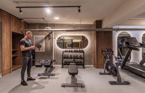 a man standing in a gym with exercise equipment at Kukun Tonala 30 Roma in Mexico City