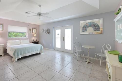 a bedroom with a bed and a table and chairs at Palm Tree Parasdise in Englewood