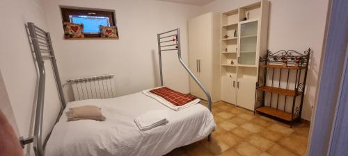 a small bedroom with a bed and a book shelf at Marsila in Camigliatello Silano