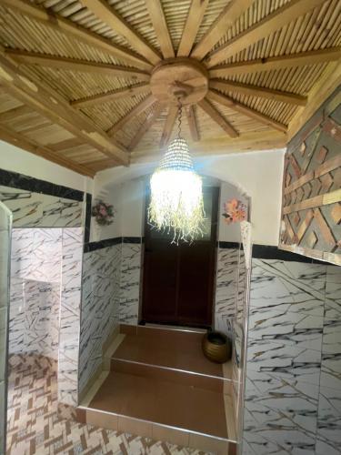 a chandelier hanging from a ceiling in a room at Red Rocks Guest House in Tamellalt