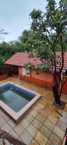 a small swimming pool in front of a house at K Bhoomi Joy by Earth in Bhīra Camp