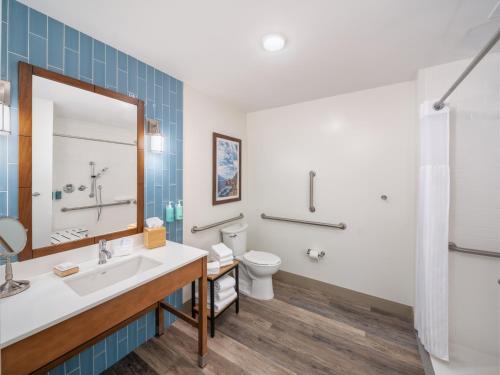 a bathroom with a sink and a toilet at Compass by Margaritaville Beaufort in Beaufort