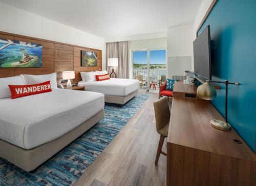 a hotel room with a bed and a desk at Compass by Margaritaville Beaufort in Beaufort