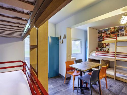 a room with a table and chairs and a bunk bed at hotelF1 Limoges in Limoges