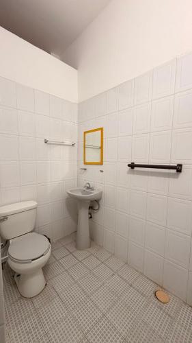 a bathroom with a toilet and a sink at Hotel Dulce Morelia in Morelia