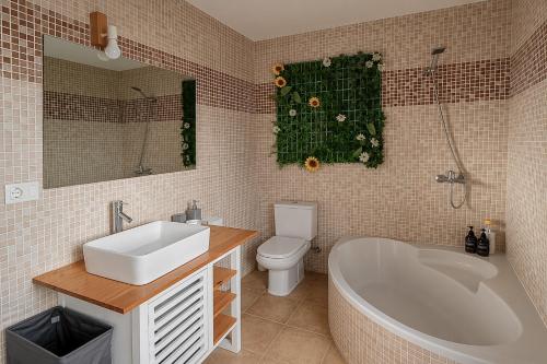 a bathroom with a sink and a tub and a toilet at O IGREXARIO Vacacional in Cangas de Morrazo