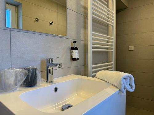 a bathroom with a sink and a mirror at Oliva Apartman in Bük
