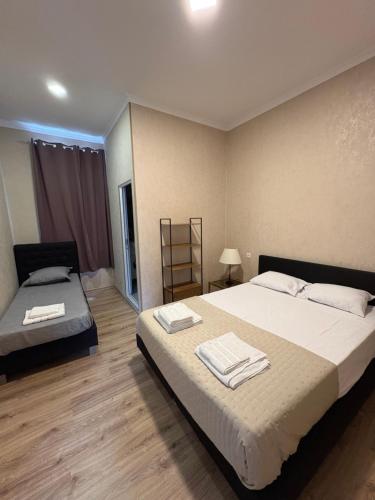 a bedroom with two beds with towels on them at Ninika B&B Utsera in Oni