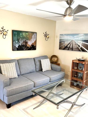 a living room with a couch and a ceiling fan at Coastal Townhome in Jupiter 1 mile to beach! in Jupiter