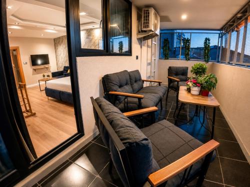 a living room with couches and a room with a bed at Taksim REXEE Istanbul Istiklal Hotel in Istanbul