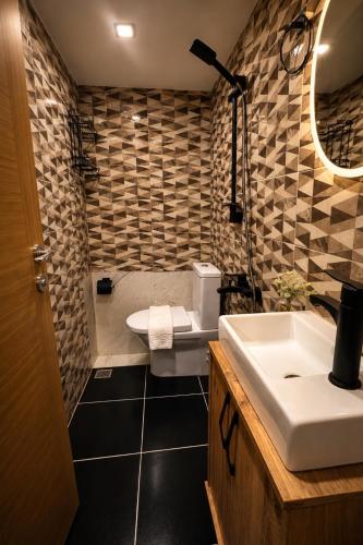 a bathroom with a white toilet and a sink at Taksim REXEE Istanbul Istiklal Hotel in Istanbul