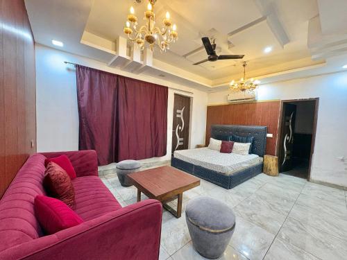a living room with a couch and a bed at Moonlight Stays in Gurgaon