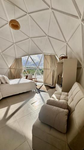 a room with a bed and a couch in a tent at Natureza e luxo in Alagoa Nova