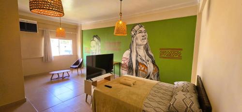 a living room with a couch and a painting on the wall at Tribus Hostel in Manaus
