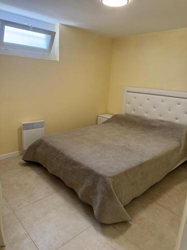 a bedroom with a large bed in a room at Maison Charmante in Donges