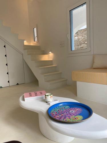 a plate on a table in a room with stairs at Lobster House Antiparos in Antiparos