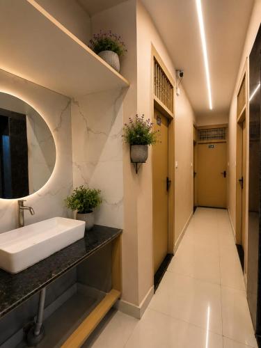 a bathroom with a sink and a mirror at Hotel Rose Inn in Prayagraj