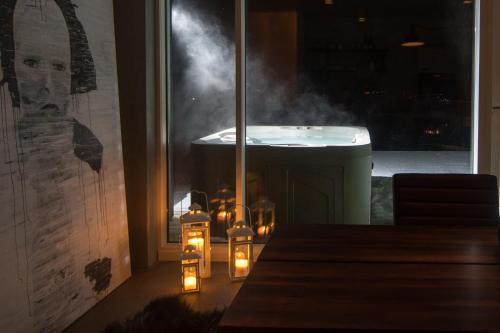 a room with candles and a bath tub with smoke at Viking Cottages & Apartments in Akureyri