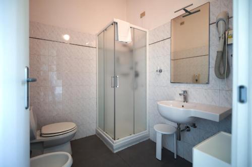 a bathroom with a toilet and a sink and a shower at Hotel La Bussola in Marina di Massa