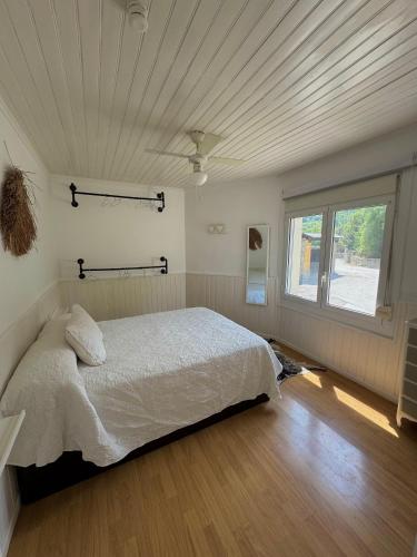 a bedroom with a bed and a large window at Casa Pont in Osséja