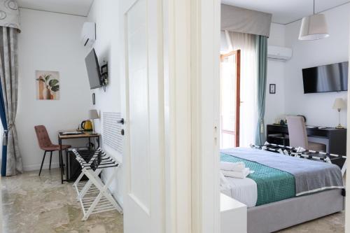 a bedroom with a bed and a desk with a computer at Dolce Vita in Messina