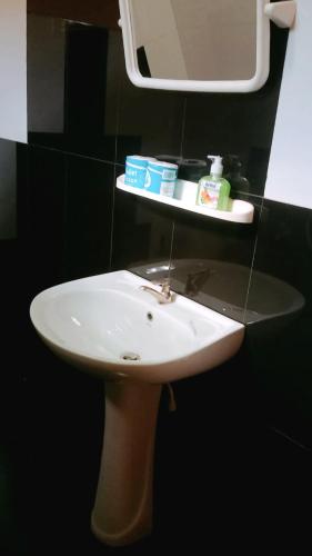 a white sink in a bathroom with a mirror at Ceylon Salt & Soul in Arugam Bay