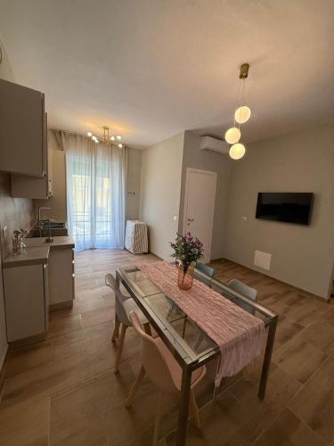 a living room with a table and a kitchen at Placanica Apartment in Calitri
