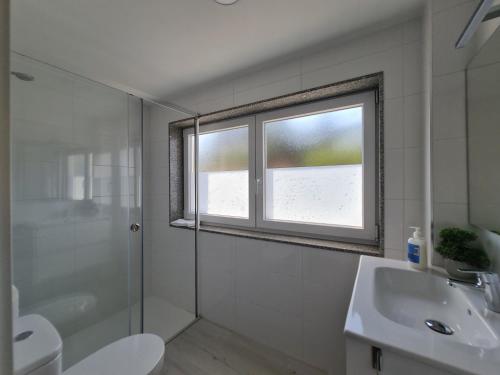 a bathroom with a shower toilet and a sink at Albergue EL CASTILLO in Sarria