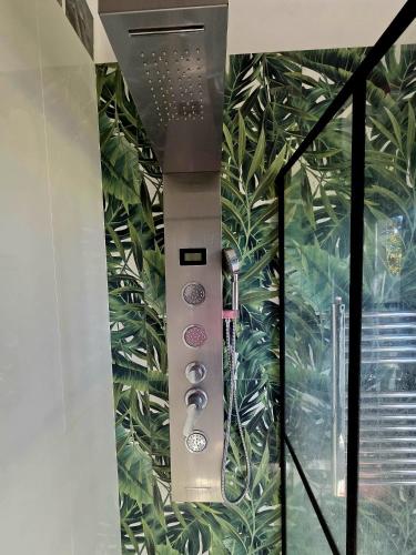a control panel in a room with plants on the wall at Elycon House Bergamo - Locazione turistica a camere in Bergamo