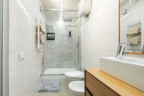 a bathroom with a sink and a toilet and a shower at Porta Toscana in Poggibonsi