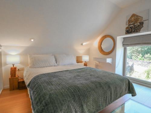 a bedroom with a large bed and a window at Little Barn in Leek