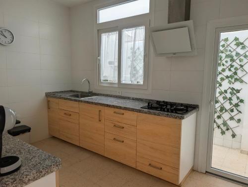a kitchen with a sink and a window at Apartamento Casa Balina II in Dúrcal