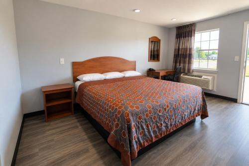 a hotel room with a bed and a window at Stay Inn Checotah near Eufaula Lake in Checotah