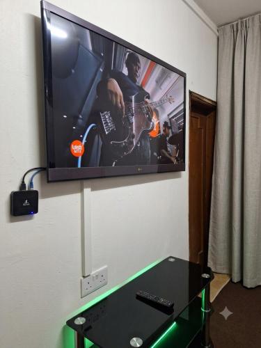 a flat screen tv hanging on a wall at Hidden Villa in Al Ain