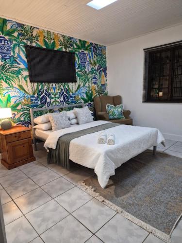 a bedroom with a bed and a wall with a mural at 52 on 2nd Self-catering accommodation in Gonubie Park