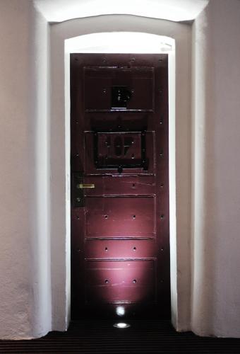 a door in a room with a red door at Malmaison Oxford in Oxford