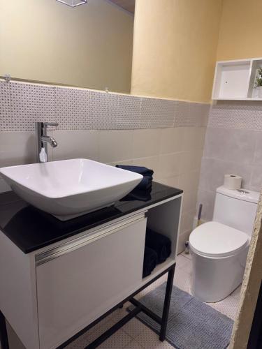 a bathroom with a sink and a toilet at The Cozy House in Estelí