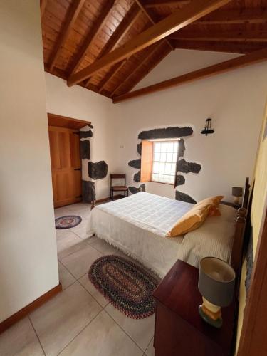 a bedroom with a large bed and a window at A Casa dos Meus Sonhos in Santo Amaro