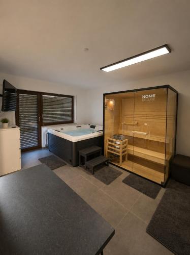 a large room with a bath tub in a room at Ferienwohnung mit Pool und Sauna - Medebach in Medebach