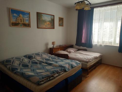 a bedroom with two beds and a window at Pod kláštorom in Svätý Beňadik