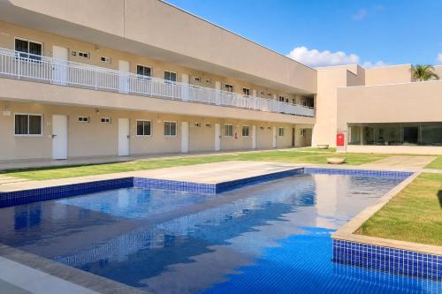 a swimming pool in front of a building at Hotel Imperador in Gurupi