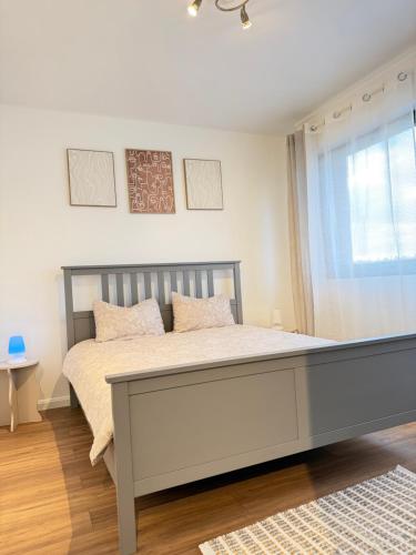 a bedroom with a large bed with a window at Le Cosy in Dunkerque